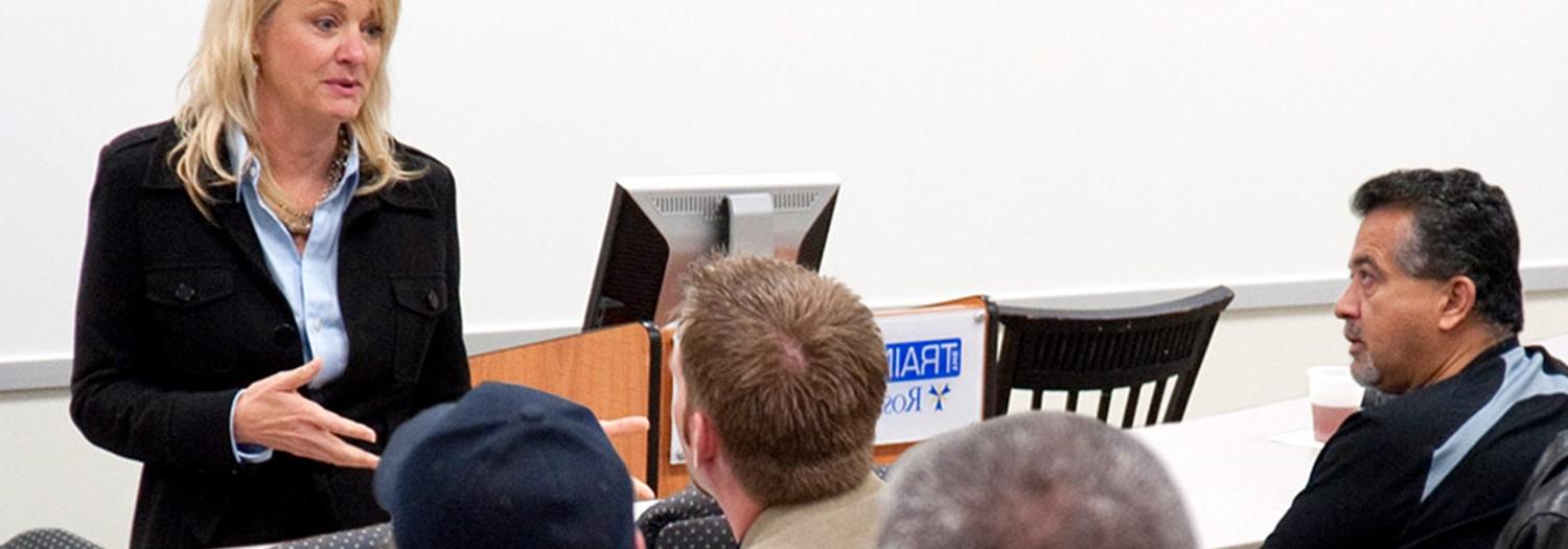 students with professor in classroom setting