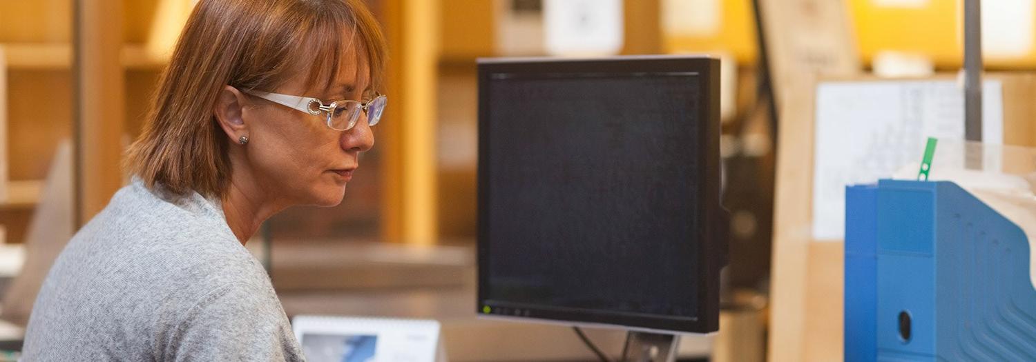 student sitting in front of a computer monitor