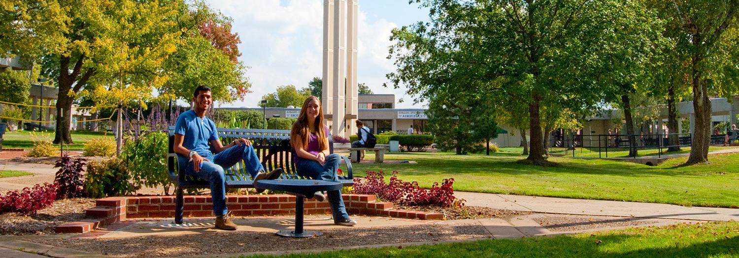 students seated in the campus mall