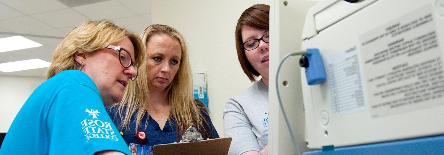 three ladies working at a computer