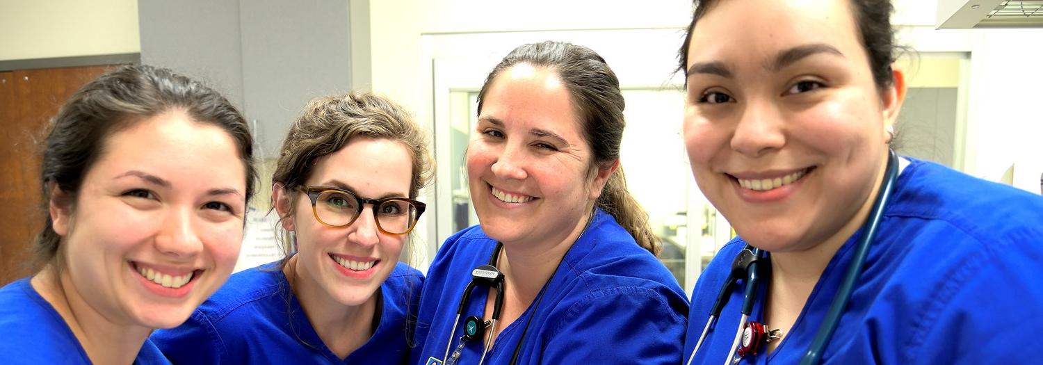 four smiling nursing students